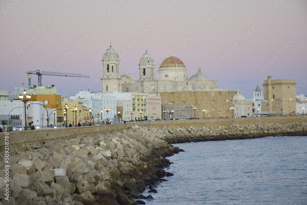 Cadiz, Spain - 06 november 2019: Seafront view of Cadiz with cathedral and street in the background, Cadiz, Spain