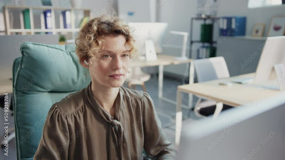 Smiling businesswoman working use computer in the office. Look at the screen and feel happy. Sunlight in modern office Smiling businesswoman working use computer in the office. Look at the screen and feel happy. Sunlight in modern office