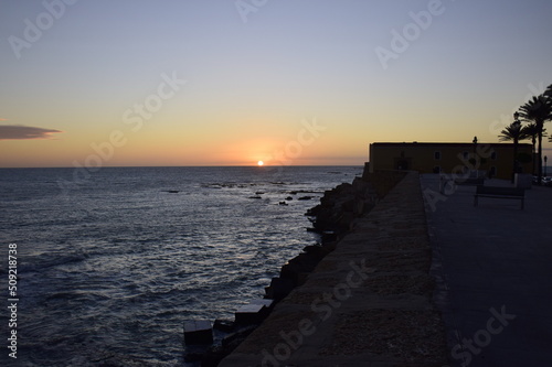 Cadiz, Spain. Sunset view in the ocean from the embankment