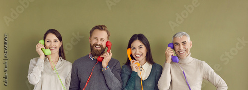 Fotografie, Tablou Group of happy people talking on colorful landline phones