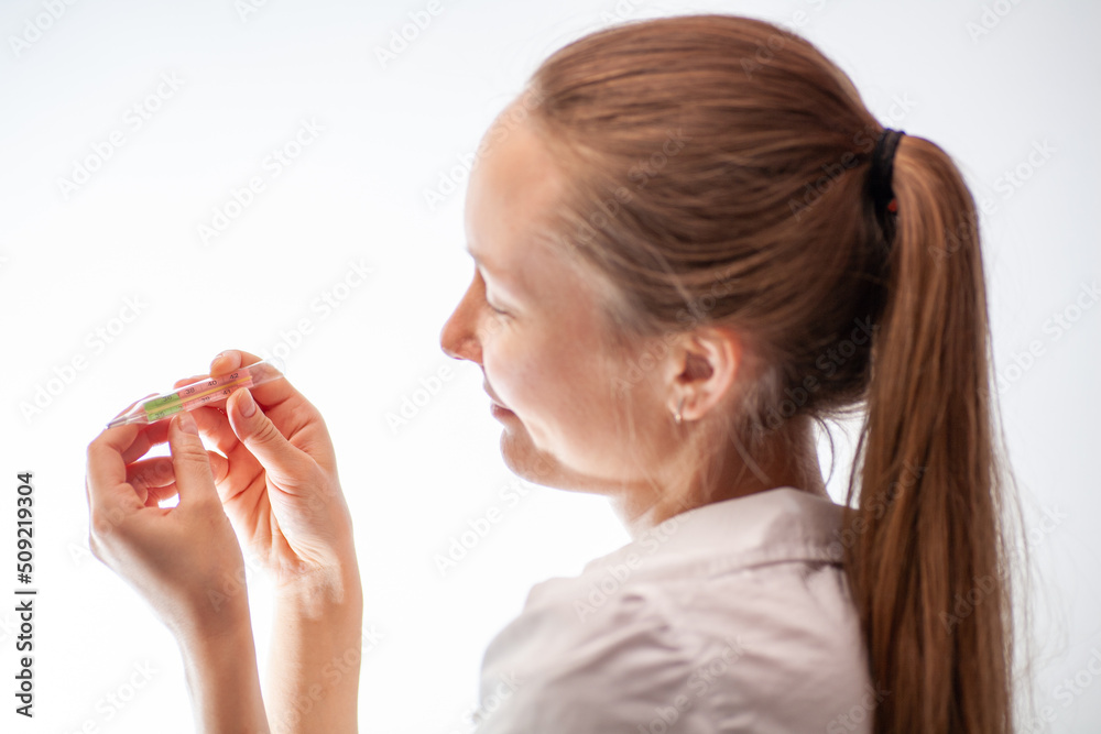 the girl measures the temperature during chills and coughs because she has a new coronavirus infection the girl measures the temperature during chills and coughs because she has a new coronavirus infection