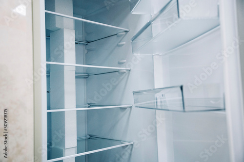 empty shelves of an open refrigerator. a new refrigerator