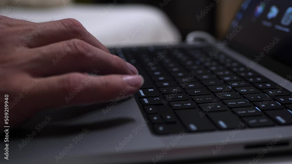 A man works on his laptop. Close-up of a slow-motion shot.