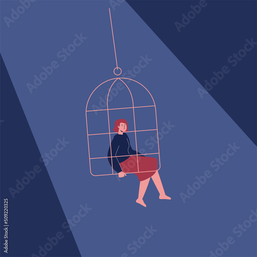 A young woman sitting in a cage, a metaphor of loneliness, depression, isolation.