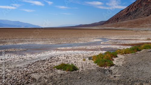 Valley of Badwater Basin dried out lake in the Death Valley National Park, California, USA. Steaming hot sunny day in the hottest place on Earth.