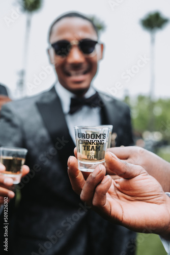 man drinking with groomsmen  photo