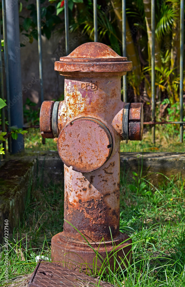 Old fire hydrant next to the sidewalk of a residential condominium, Rio Old fire hydrant next to the sidewalk of a residential condominium, Rio