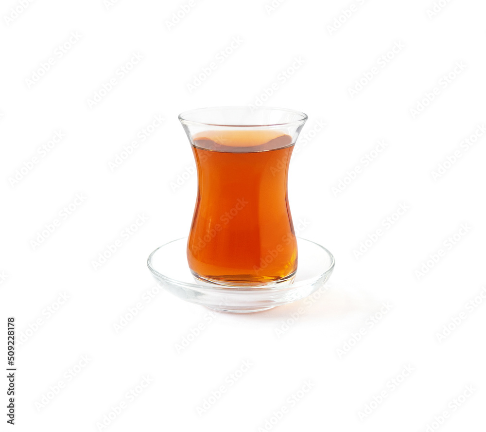 Turkish armudu glass on saucer with black tea isolated on white background Turkish armudu glass on saucer with black tea isolated on white background