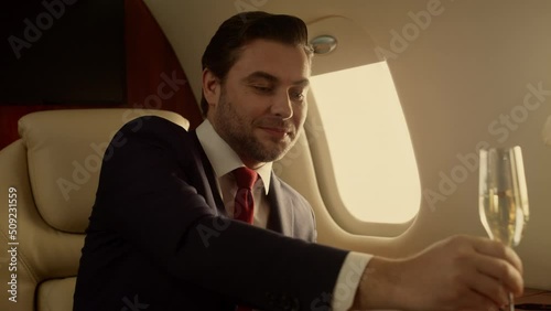 Smiling entrepreneur relaxing jet closeup. Attractive drink champaign sunlight