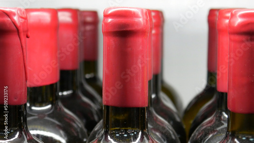 Close-up of many wine bottles with red sealing wax corks