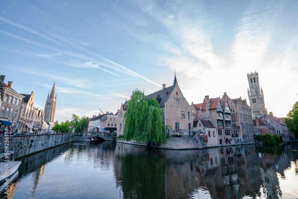 Obraz premium Canal in Bruges and Belfry tower - Houses and Streets - Bruges, Belgium - the city centre