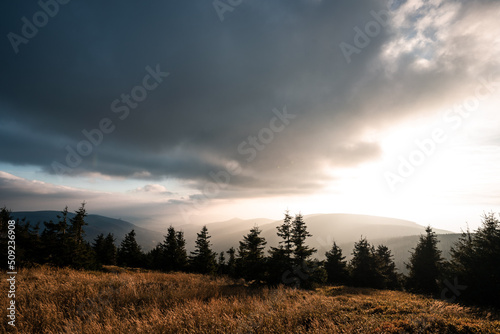 Landscape of warm light sun rays on sky through the clouds over the mountains in Czech republic, Jeseniky