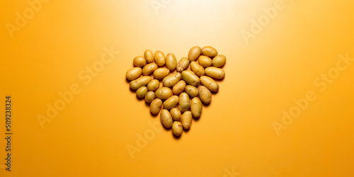 potatos in a heart shape on orange background