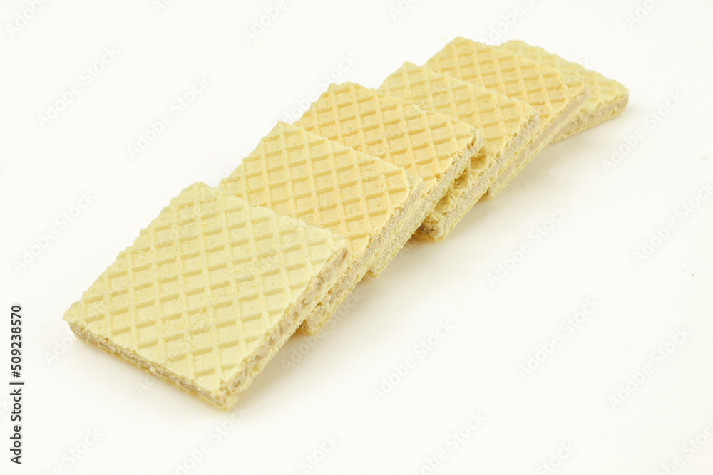 Stack of thin vanilla filled wafer biscuits isolated on white background