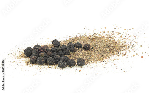 Pile of black ground pepper and peppercorns isolated on a white background