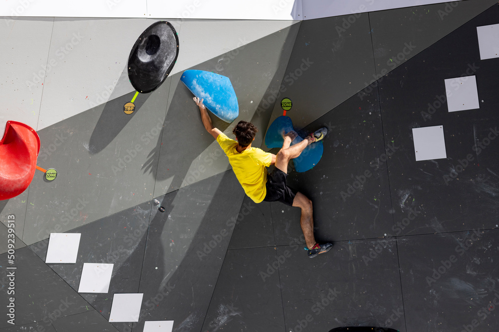 Climbing. Sport. Young person climbing in Block Climbing. Olympic