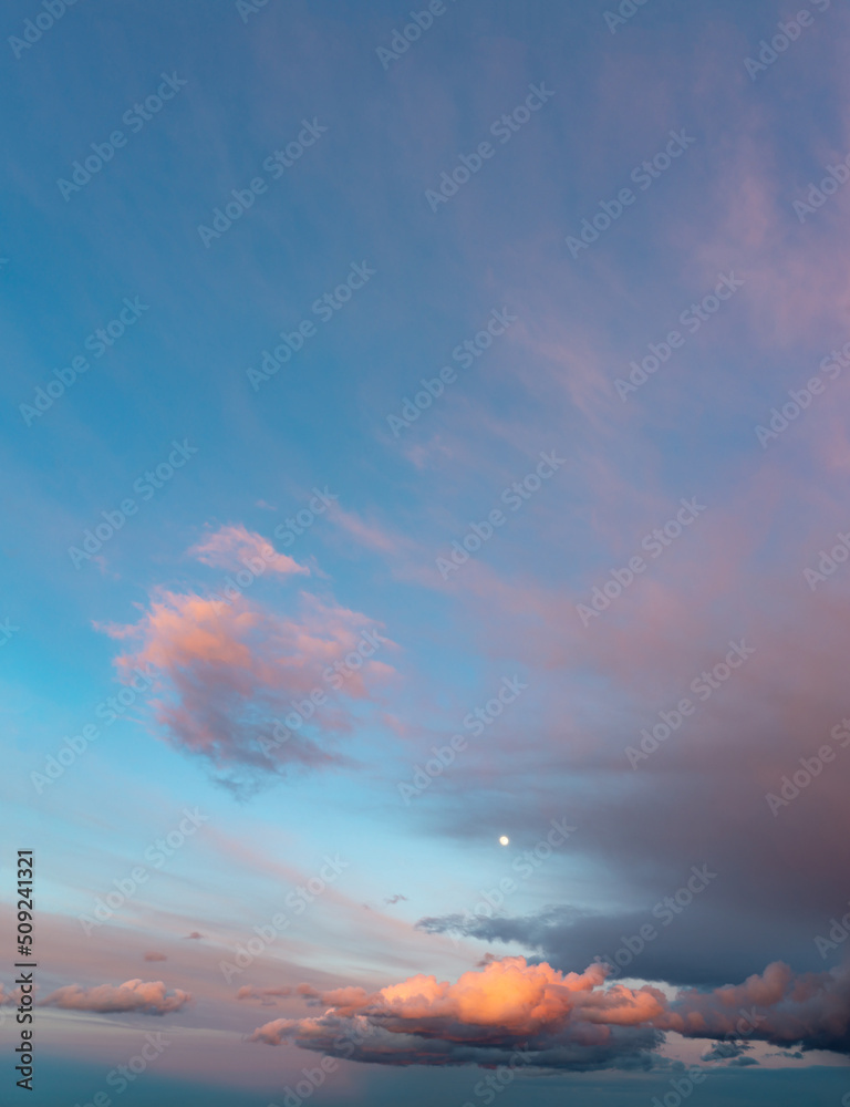 Fototapeta premium Fantastic thunderclouds at sunrise, vertical panorama