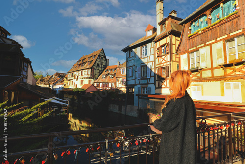 Tourist enjoy the view of Traditional half-timbered houses on the river bank in Colmar , Alsace rigion, France