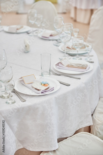 Table setting with plate, white napkin and cutlery on table, copy space. Place set at wedding reception. Table served for wedding banquet in restaurant © mirage_studio