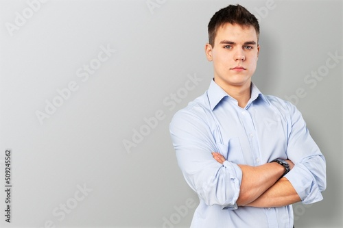 Portrait of smiling mature man standing and posing on background. © BillionPhotos.com
