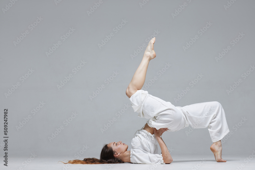 Beautiful young modern dancer or fitness dancer on a white isolated background - obrazy, fototapety, plakaty 