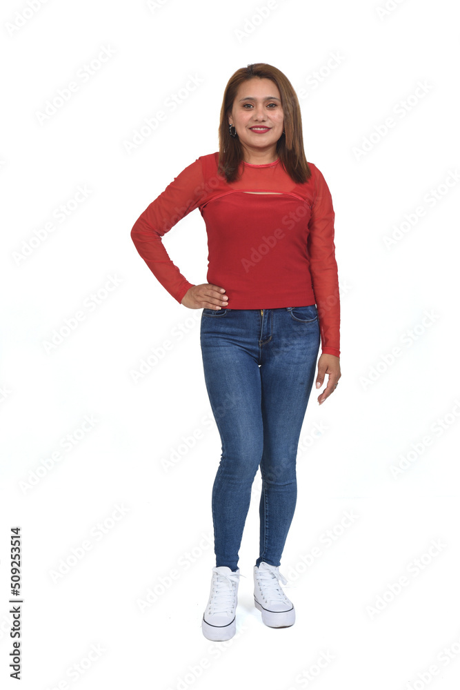 front view of a full portrait of a women with jeans and sneaker looking at camera and hand on hip over white background front view of a full portrait of a women with jeans and sneaker looking at camera and hand on hip over white background