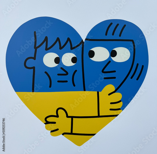 Boston, USA, June 2022, a heart in the national colors (national flag) of Ukraine with two faces hug each other 