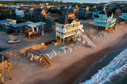 фотографія Aerial view of a beach home and a vacant lot from a home that collapsed into the