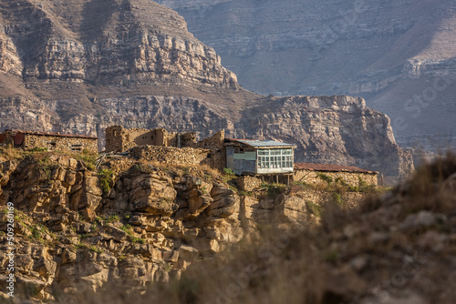 Abandoned house on the mountain. Stone house in Dagestan, Russia. Desert village on a slope