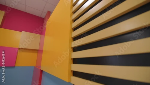 Wallpaper Mural Bright color geometric elements on grey walls of building hallway close view. Interior design of children center Torontodigital.ca