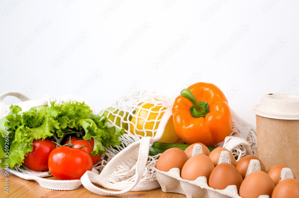 Vegetables and eggs in eco-friendly containers. Zero waste. Sustainable shopping.Paper cup Vegetables and eggs in eco-friendly containers. Zero waste. Sustainable shopping.Paper cup