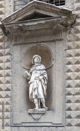 Statue of Saint Alexius in a niche of the façade of the basilica of Santa Trinita, built in the 13th century, Florence city center, Tuscany region, Italy photo