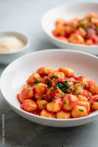 Gnocchi with tomato sauce and parmigiano on a plate