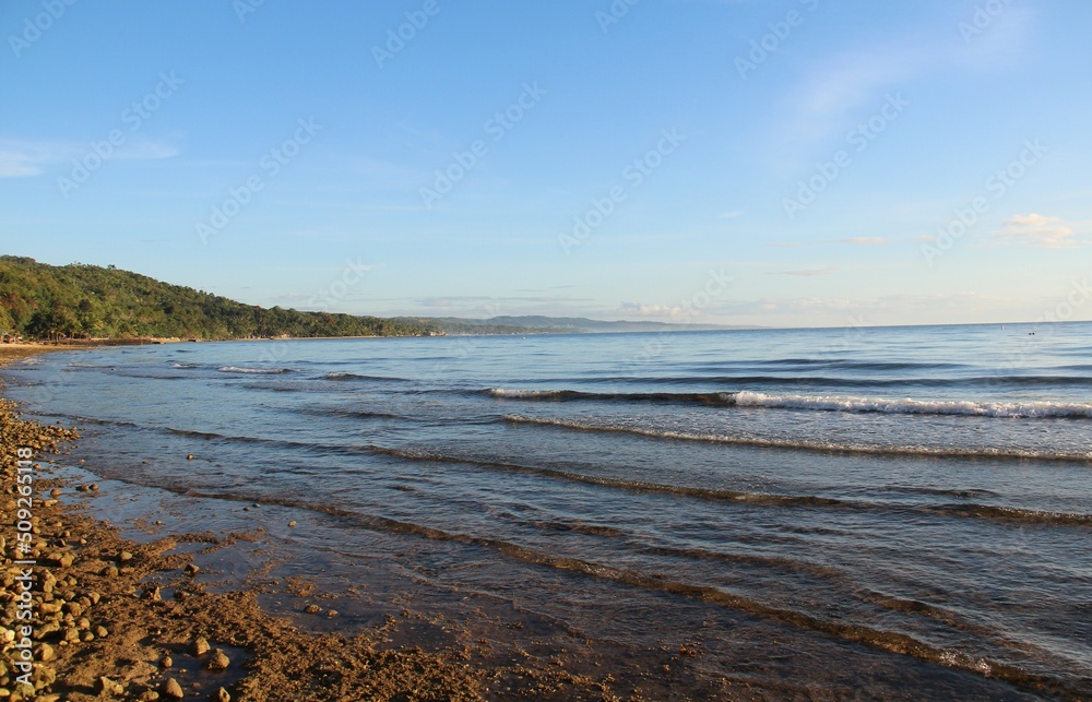 Layer of gentle waves of the ocean in the morning sun, Sogod, Cebu, Philippines