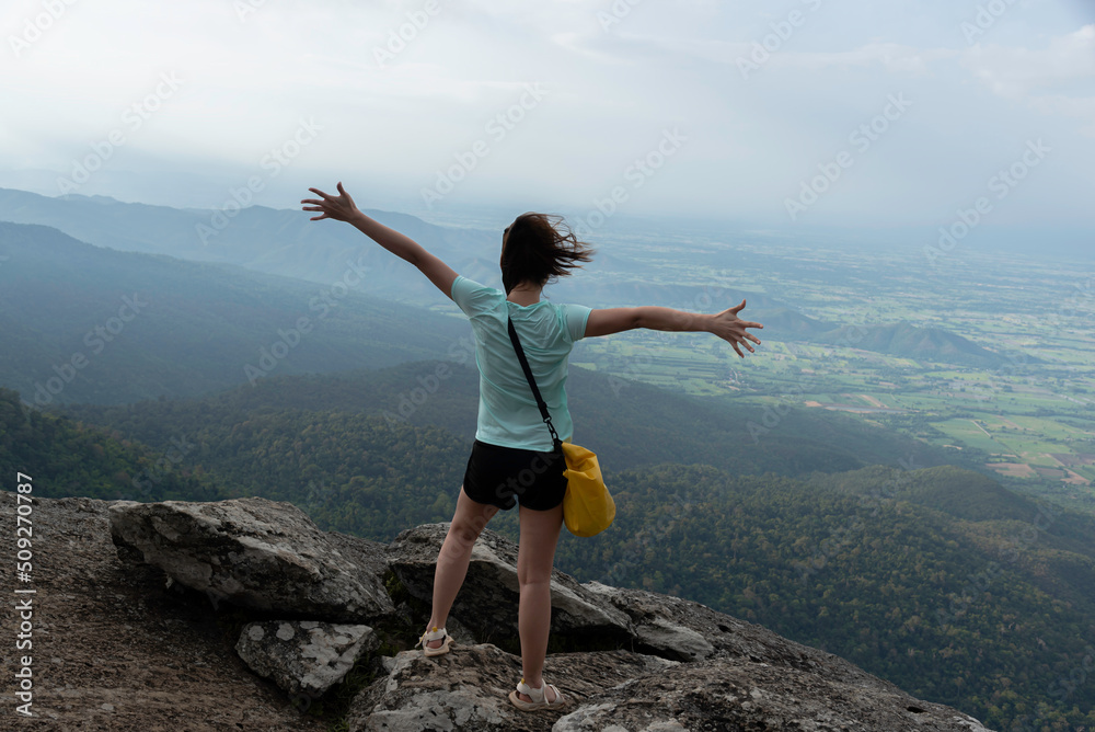 Hiker with backpack relaxing young woman and looking at amazing mountains and forest, wanderlust travel concept, space for text, atmospheric epic moment hiking holiday Hiker with backpack relaxing young woman and looking at amazing mountains and forest, wanderlust travel concept, space for text, atmospheric epic moment hiking holiday