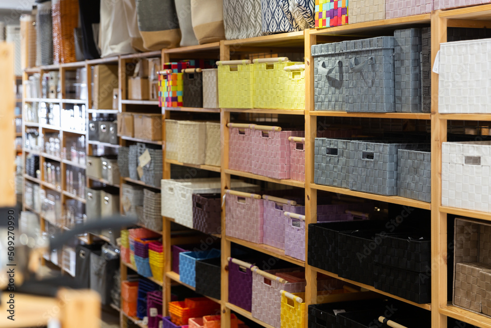 Variety of storage boxes and baskets on shelves at modern furnishings store