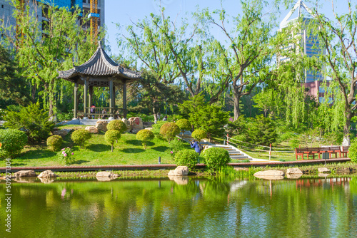 Changchun, Jilin - April 3 2021: Chinese pavilion architecture in a city park in summer.