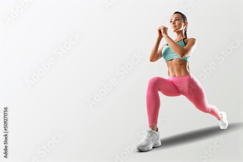 Portrait of sportswoman stretching body  exercising  doing fitness and smiling 