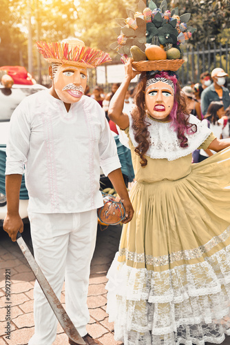 Man and woman with costumes of El Viejo and La Vieja, a traditional dance typical of Nicaragua during a festival in Masaya city