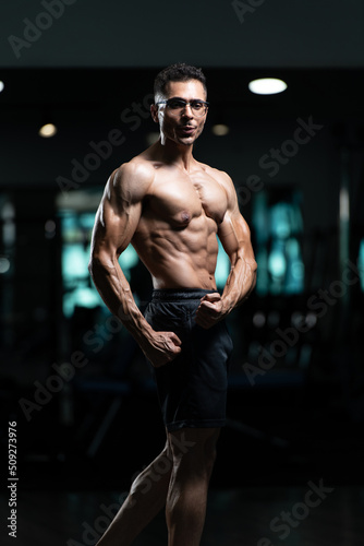 Bodybuilder With Gynecomastia Problem Showing Abdominal Muscle
