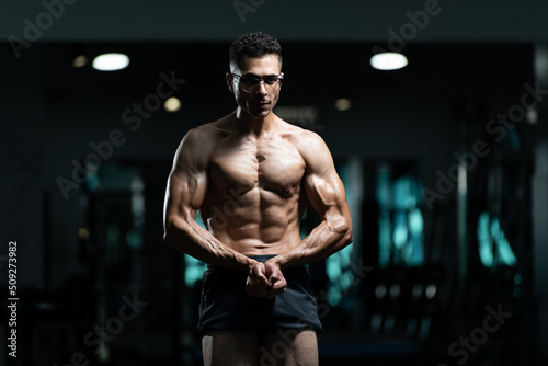 Man With Gynecomastia Problem Flexing Muscles