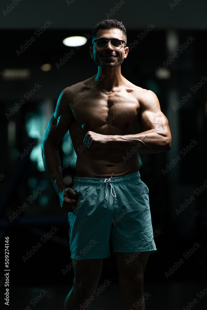 Bodybuilder With Problem Flexing Muscles Stock Photo