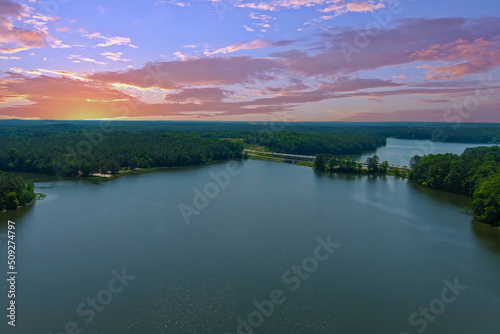 breathtaking aerial shot of the vast blue waters of Lake Acworth surrounded by miles of lush green trees with powerful clouds at sunset at Cauble Park in Acworth Georgia USA photo
