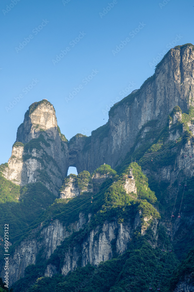 Cable cars going on top of the Tianmen mountain, Zhangjiajie, China, vertical image, blue sky with copy space for text