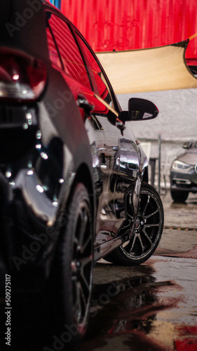 car on wet floor with reflections