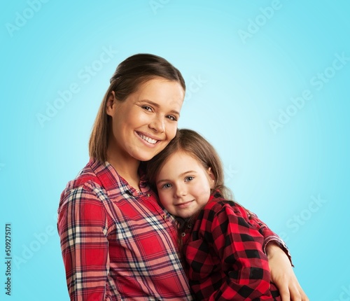 Mother's Love Concept. Portrait of happy young mom cuddling her cute tween daughter