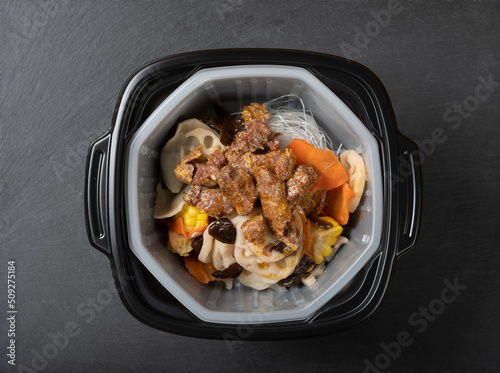 self-cooking hotpot with noodles about to be cooked photo