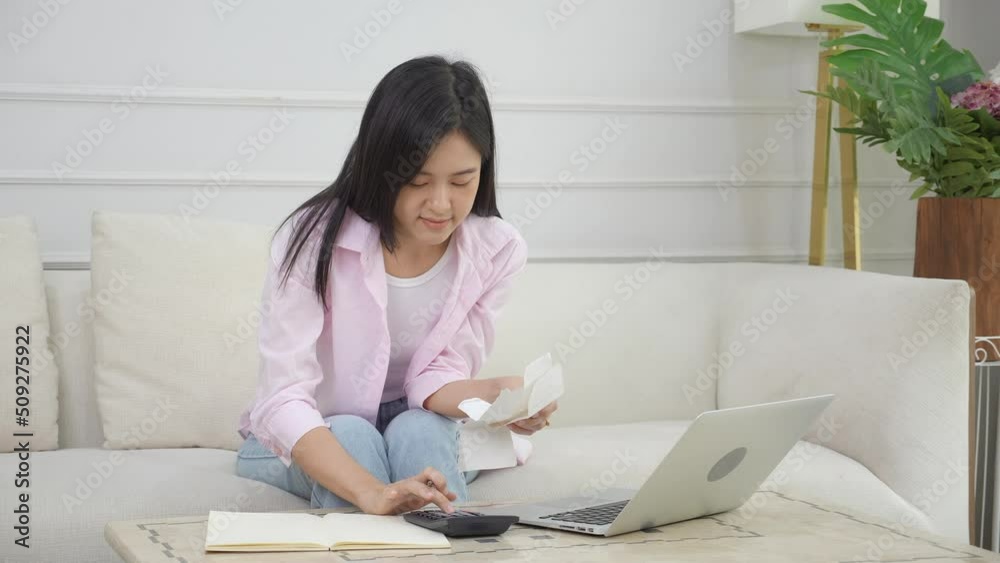 Young asian woman calculating expenses household about finance and frustrated at home, girl checking bill having stress and worried, debt and tax, expression and emotion tired, business concept. Young asian woman calculating expenses household about finance and frustrated at home, girl checking bill having stress and worried, debt and tax, expression and emotion tired, business concept.