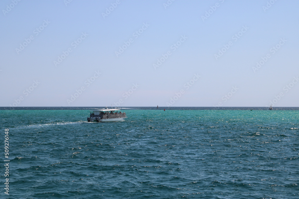 tourist boat sailing in the open ocean