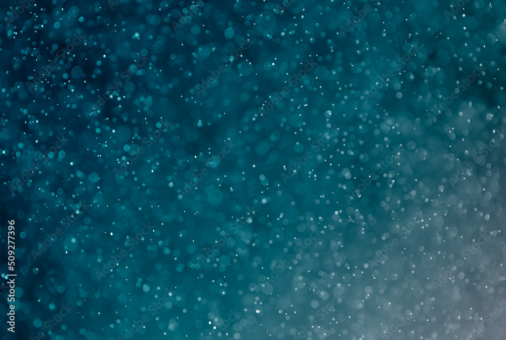 Obraz premium Abstract blurred glitter on blue light effects background.